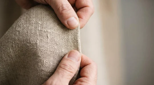 Close examination of high-quality fabric texture revealing intricate weave patterns and natural fiber characteristics